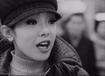 A young woman wearing a hat and a jacket