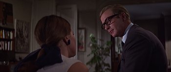 Movie still from “Funeral in Berlin” (1966), directed by Guy Hamilton – A man and a woman talking to each other; Close Up shot, Over the shoulder angle
