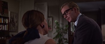 Movie still from “Funeral in Berlin” (1966), directed by Guy Hamilton – A man and a woman talking to each other; Close Up shot, Over the shoulder angle