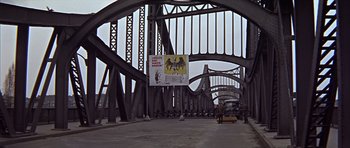 Movie still from “Funeral in Berlin” (1966), directed by Guy Hamilton – An image of a bridge that is under construction; Extreme Wide shot, Low angle