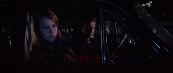 Movie still from “Funeral in Berlin” (1966), directed by Guy Hamilton – A man and a woman in the back seat of a car; Close Up shot, Over the shoulder angle