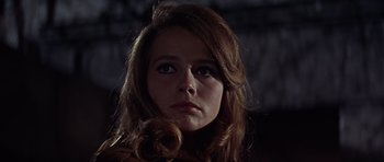 Movie still from “Funeral in Berlin” (1966), directed by Guy Hamilton – A person with long red hair; Close Up shot, Low angle