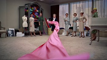 Movie still from “Funny Face” (1957), directed by Stanley Donen – A group of people standing in a room; Wide shot, Low angle