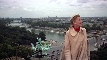Movie still from “Funny Face” (1957), directed by Stanley Donen – A woman standing on a ledge overlooking a city; Medium shot, Low angle