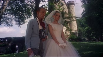 Movie still from “Funny Face” (1957), directed by Stanley Donen – A man and a woman dressed in a wedding dress; Medium shot, Low angle
