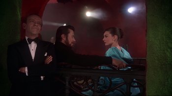 Movie still from “Funny Face” (1957), directed by Stanley Donen – A man and a woman sitting at a table; Medium shot, Low angle