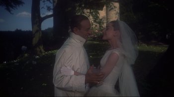 Movie still from “Funny Face” (1957), directed by Stanley Donen – A man and a woman in a white wedding dress; Medium shot, Low angle