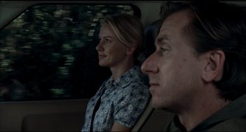 Movie still from “Funny Games” (2007), directed by Michael Haneke – A man and a woman sitting in a car looking out the window; Close Up shot, Over the shoulder angle