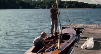 Movie still from “Funny Games” (2007), directed by Michael Haneke – A man and a child on a small boat; Wide shot, High angle