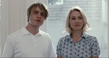 Movie still from “Funny Games” (2007), directed by Michael Haneke – A man and a woman standing next to each other; Close Up shot, Over the shoulder angle