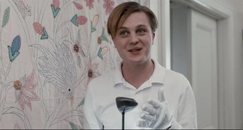 Movie still from “Funny Games” (2007), directed by Michael Haneke – A man in a white shirt holding a golf club in his hand; Close Up shot, Low angle
