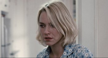 Movie still from “Funny Games” (2007), directed by Michael Haneke – A person with short blonde hair; Close Up shot, Over the shoulder angle