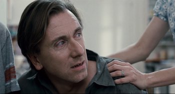 Movie still from “Funny Games” (2007), directed by Michael Haneke – A person wearing a ring on his shoulder; Close Up shot, Over the shoulder angle