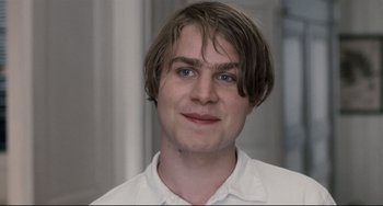 Movie still from “Funny Games” (2007), directed by Michael Haneke – A person wearing a white shirt; Close Up shot, Over the shoulder angle