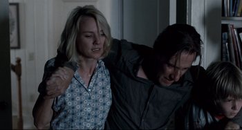 Movie still from “Funny Games” (2007), directed by Michael Haneke – A man and a woman are fighting in a room; Medium shot, Low angle