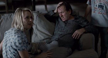 Movie still from “Funny Games” (2007), directed by Michael Haneke – A man and a woman sitting on a couch; Medium shot, High angle