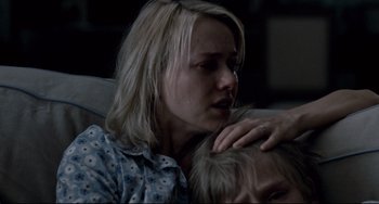 Movie still from “Funny Games” (2007), directed by Michael Haneke – A woman sitting next to a man on a couch; Close Up shot, Over the shoulder angle