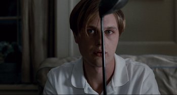 Movie still from “Funny Games” (2007), directed by Michael Haneke – A young man is looking at the camera; Close Up shot, Low angle