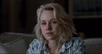 Movie still from “Funny Games” (2007), directed by Michael Haneke – A person sitting on a couch; Close Up shot, Over the shoulder angle