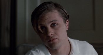 Movie still from “Funny Games” (2007), directed by Michael Haneke – A person wearing a white shirt; Close Up shot, Low angle