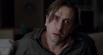 Movie still from “Funny Games” (2007), directed by Michael Haneke – A person wearing a shirt; Close Up shot, Over the shoulder angle