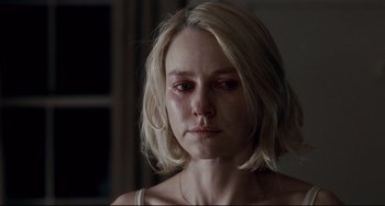 Movie still from “Funny Games” (2007), directed by Michael Haneke – A woman with blonde hair is crying in a room; Close Up shot, Over the shoulder angle