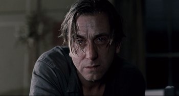 Movie still from “Funny Games” (2007), directed by Michael Haneke – A person with long dark hair; Close Up shot, Low angle