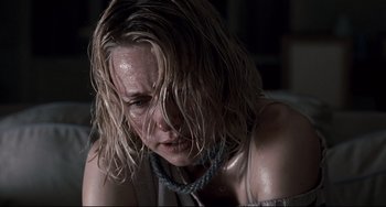 Movie still from “Funny Games” (2007), directed by Michael Haneke – A person with wet hair; Close Up shot, Low angle
