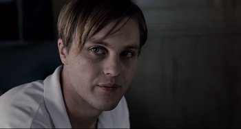 Movie still from “Funny Games” (2007), directed by Michael Haneke – A person wearing a white shirt; Close Up shot, Low angle