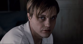 Movie still from “Funny Games” (2007), directed by Michael Haneke – A person wearing a white shirt; Close Up shot, Low angle