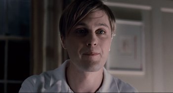 Movie still from “Funny Games” (2007), directed by Michael Haneke – A person wearing a white shirt; Close Up shot, Low angle