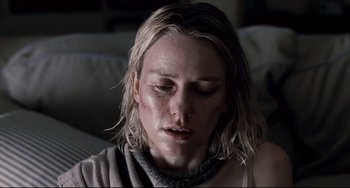 Movie still from “Funny Games” (2007), directed by Michael Haneke – A person sitting on a couch; Close Up shot, Low angle