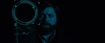 Movie still from “G-Force” (2009), directed by Hoyt Yeatman – A man with a beard is looking at the camera; Close Up shot, Overhead angle