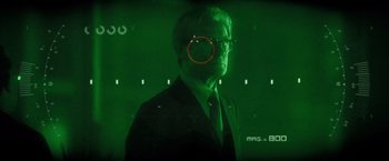 Movie still from “G-Force” (2009), directed by Hoyt Yeatman – A man in a black suit and a red circle in the middle of his face; Close Up shot, Over the shoulder angle