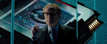 Movie still from “G-Force” (2009), directed by Hoyt Yeatman – A man in a suit and tie smoking a cigarette; Close Up shot, Over the shoulder angle