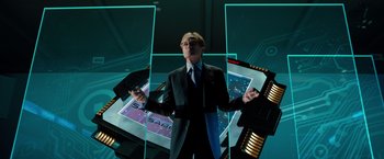 Movie still from “G-Force” (2009), directed by Hoyt Yeatman – A man standing in front of a computer screen; Medium shot, Overhead angle