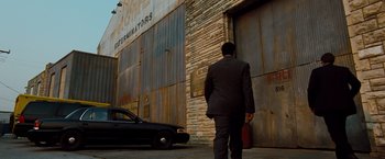 Movie still from “G-Force” (2009), directed by Hoyt Yeatman – A man in a business suit walking down the street; Extreme Wide shot, Low angle