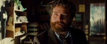 Movie still from “G-Force” (2009), directed by Hoyt Yeatman – A man with a beard wearing a suit and tie; Close Up shot, Over the shoulder angle