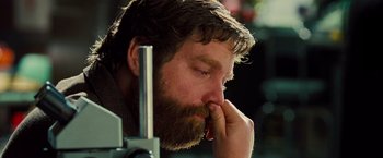Movie still from “G-Force” (2009), directed by Hoyt Yeatman – A man with a goatee and a beard is leaning on a camera; Close Up shot, Low angle