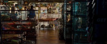 Movie still from “G-Force” (2009), directed by Hoyt Yeatman – A room filled with lots of cages and a table; Wide shot, Over the shoulder angle