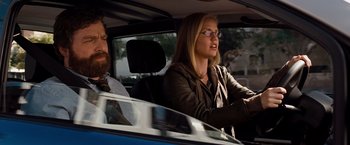 Movie still from “G-Force” (2009), directed by Hoyt Yeatman – A woman driving a car while a man sits in the driver's seat; Medium shot, Over the shoulder angle