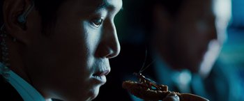 Movie still from “G-Force” (2009), directed by Hoyt Yeatman – A man is eating a piece of food with a fork; Extreme Close Up shot, Over the shoulder angle
