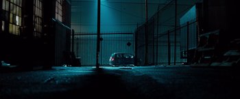 Movie still from “G-Force” (2009), directed by Hoyt Yeatman – A car parked in front of a fence at night; Extreme Wide shot, Low angle