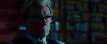 Movie still from “G-Force” (2009), directed by Hoyt Yeatman – An older man wearing glasses and a tie; Close Up shot, Over the shoulder angle