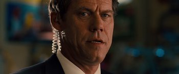 Movie still from “G-Force” (2009), directed by Hoyt Yeatman – A person wearing a suit and tie; Close Up shot, Over the shoulder angle