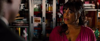 Movie still from “G-Force” (2009), directed by Hoyt Yeatman – A woman with a flower in her hair standing in front of a refrigerator; Close Up shot, Over the shoulder angle