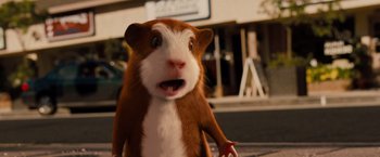 Movie still from “G-Force” (2009), directed by Hoyt Yeatman – A brown and white hamster standing next to a building; Close Up shot, Low angle