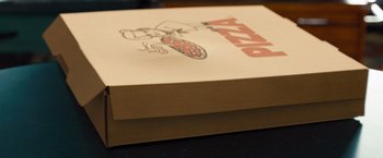 Movie still from “G-Force” (2009), directed by Hoyt Yeatman – A pizza box sitting on top of a wooden table; Extreme Close Up shot, High angle