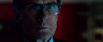Movie still from “G-Force” (2009), directed by Hoyt Yeatman – A person wearing glasses and a suit; Close Up shot, Low angle