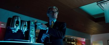 Movie still from “G-Force” (2009), directed by Hoyt Yeatman – A man standing in front of a bar holding a glass; Medium shot, Low angle